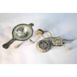 A Victorian silver plated skirt lifter with an urn and fruit design along with a Danish silver