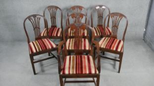 A set of seven Hepplewhite style mahogany dining chairs with wheatsheaf carved and pierced splat