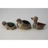 Three Danish silver animal novelty pin cushions. One as a partridge with green velvet cushion, one