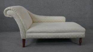 A Victorian style chaise in floral damask upholstery on turned baluster supports. H.80 W.142 D.66cm
