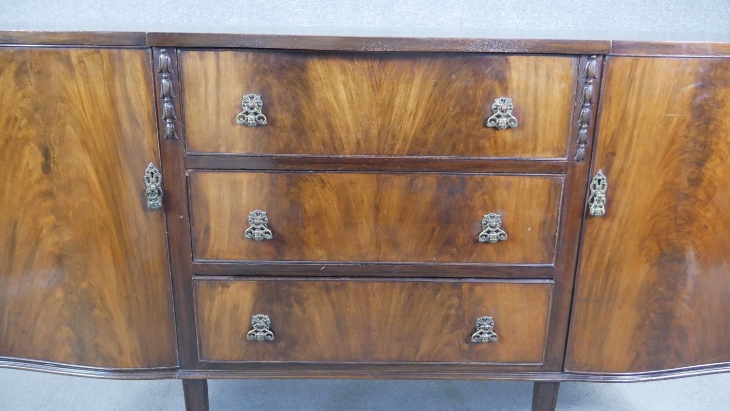 A Georgian style flame mahogany sideboard with husk carved decoration on square tapering supports. - Image 5 of 8