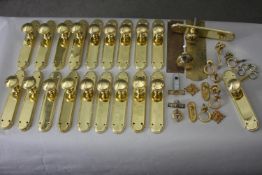 A collection of twenty brass door fittings and parts. Including doorknobs and door plates, cabinet