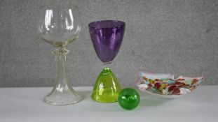 A collection of glass. Including a green and purple art glass hours design goblet, a colourful swirl