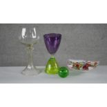 A collection of glass. Including a green and purple art glass hours design goblet, a colourful swirl