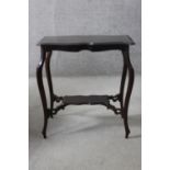 A C.1900 shaped top occasional table on cabriole supports united by under tier. H.67 W.64 D.41 cm.