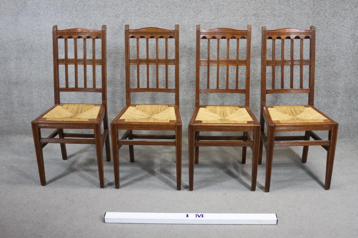 A set of four late 19th century mahogany dining chairs with drop in woven rush seats on square - Image 4 of 4