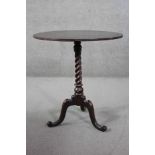 A 19th century mahogany occasional table on spiral twist cabriole supports. H.70 Diam. 62 cm