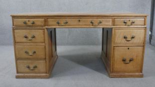 A C.1900 light oak three section pedestal desk with brass swan neck handles on platform base. H.76