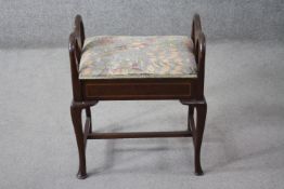 An Edwardian mahogany and satinwood inlaid piano stool with hinged sheet music storage seat on