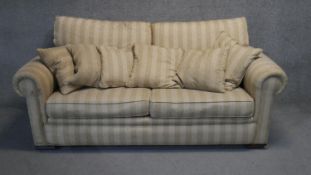 A contemporary two seater sofa in floral striped upholstery.