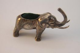 A Danish silver elephant pin cushion with green velvet cushion, stamped to base of foot 925 and T.F.