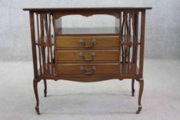 A C.1900 mahogany music cabinet fitted with fall front sheet music drawers raised on slender