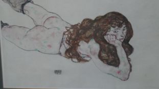 A framed and glazed print of Female nude lying on her stomach by Egon Schiele. H.45 W.60cm
