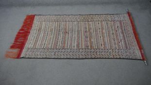 A fine hand woven Moroccan wall hanging with hanging pole. L.180 W100cm