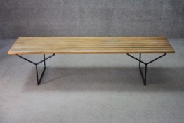 A mid century vintage Heal's hall bench with beech slatted seat on metal frame. Comes with