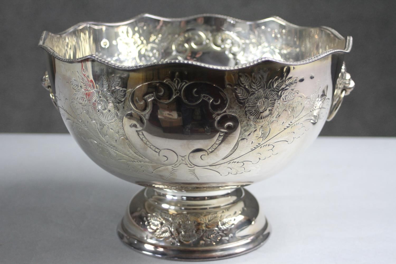 A hand chased floral design silver plate punch bowl and ladle. The pedestal bowl with twin lion head - Image 3 of 9