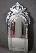 A Venetian style pier mirror with arched plate in etched glass frame and cresting. H.120 W.60 cm.