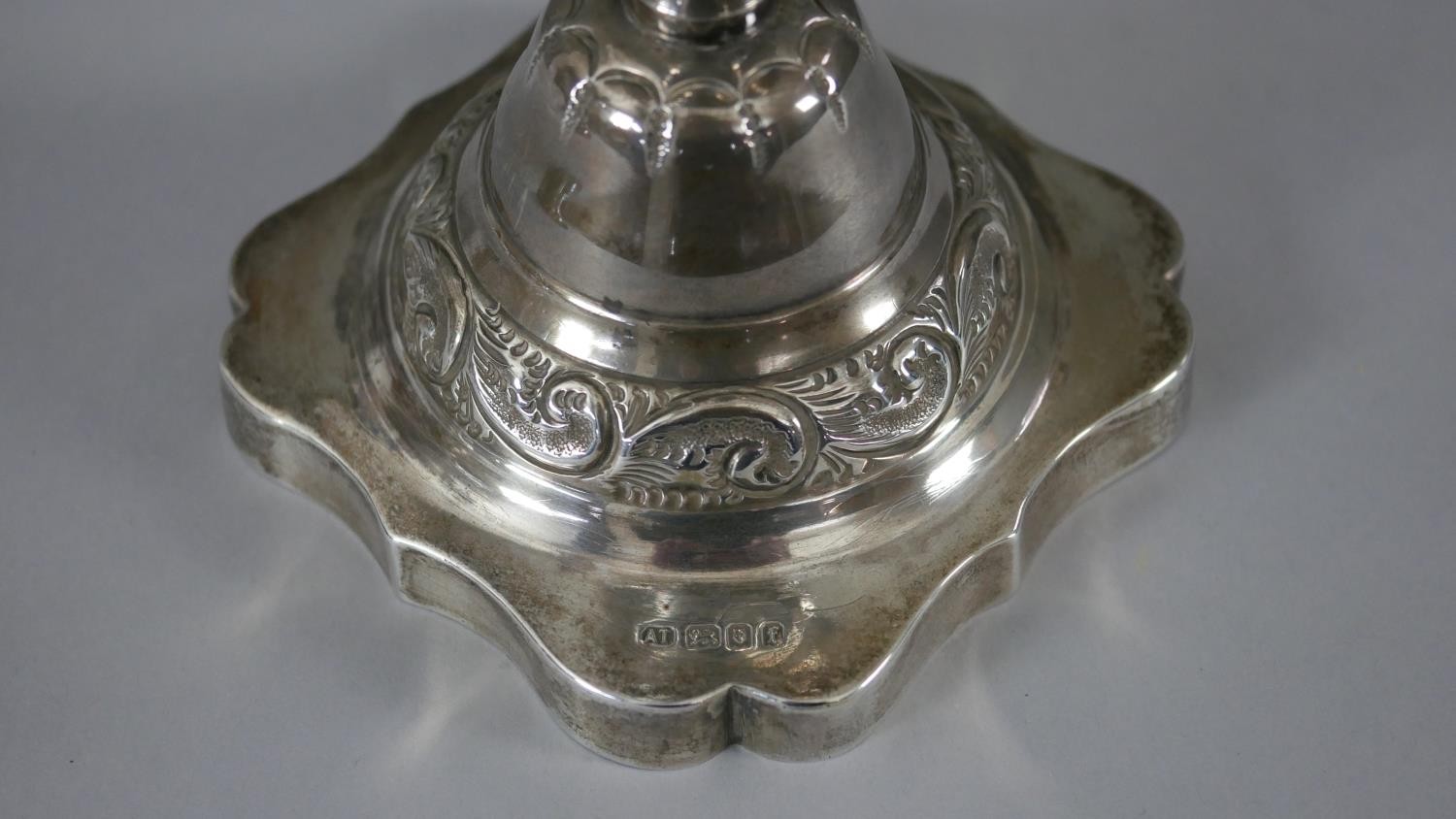 A pair of 1920'a repousse silver candlesticks with scrolling foliate design on scalloped bases. - Image 4 of 8