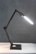A black LED anglepoise style strip lamp on weighted base. H.95 W.20cm.