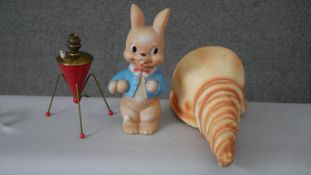 A collection of novelty items. Including a painted papier-mâché conch shell, a vintage rubber lamp