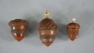 Three 19th century coquilla nut acorn design thimble holders. Each with a repeating foliate design