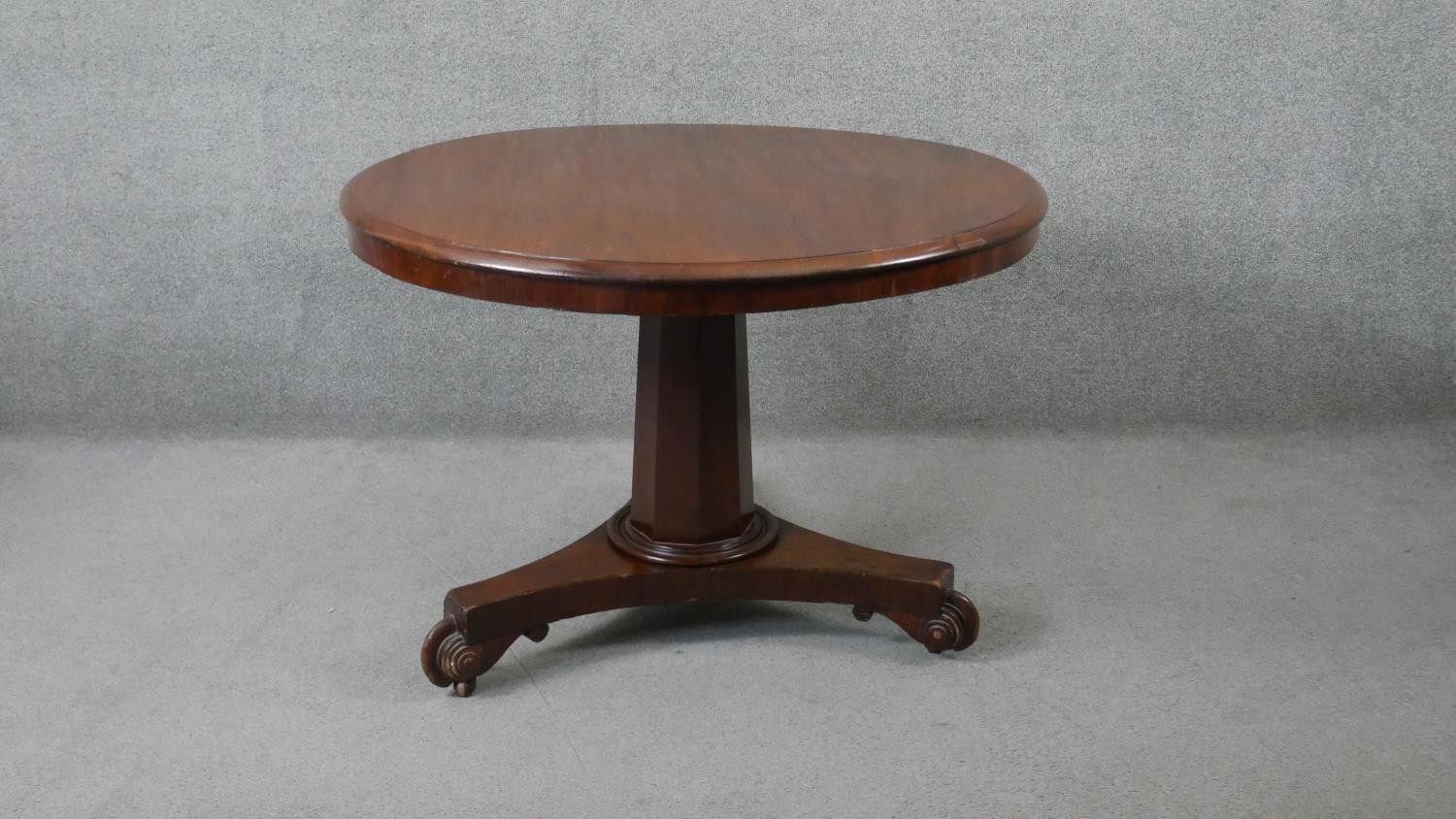A 19th century mahogany tilt top dining table on faceted triform platform base. H.70 Diam.103cm