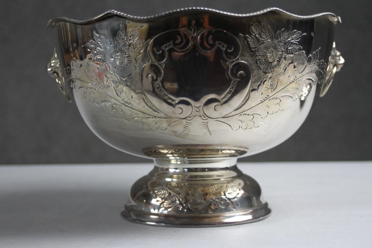 A hand chased floral design silver plate punch bowl and ladle. The pedestal bowl with twin lion head - Image 4 of 9