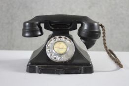 A GPO vintage 1920's black bakelite dial telephone marked 1/232CB, FWR 59/2, with pull out directory