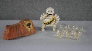 A vintage cast iron painted Michelin man figure along with a rubber Dougal from the Magic Roundabout