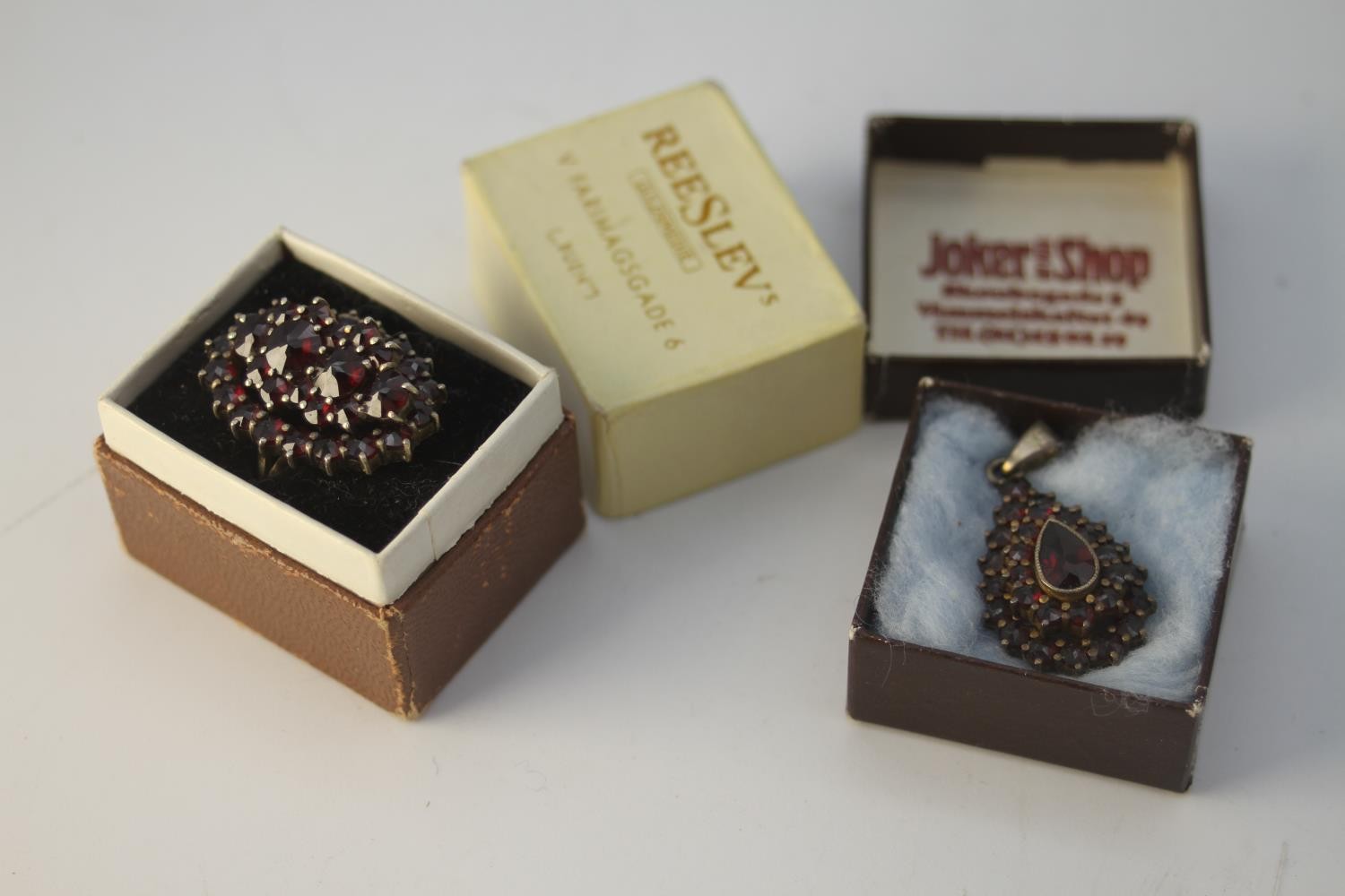 An early 20th century Bohemian garnet ring (damaged) and drop shape cluster pendant. The ring set in