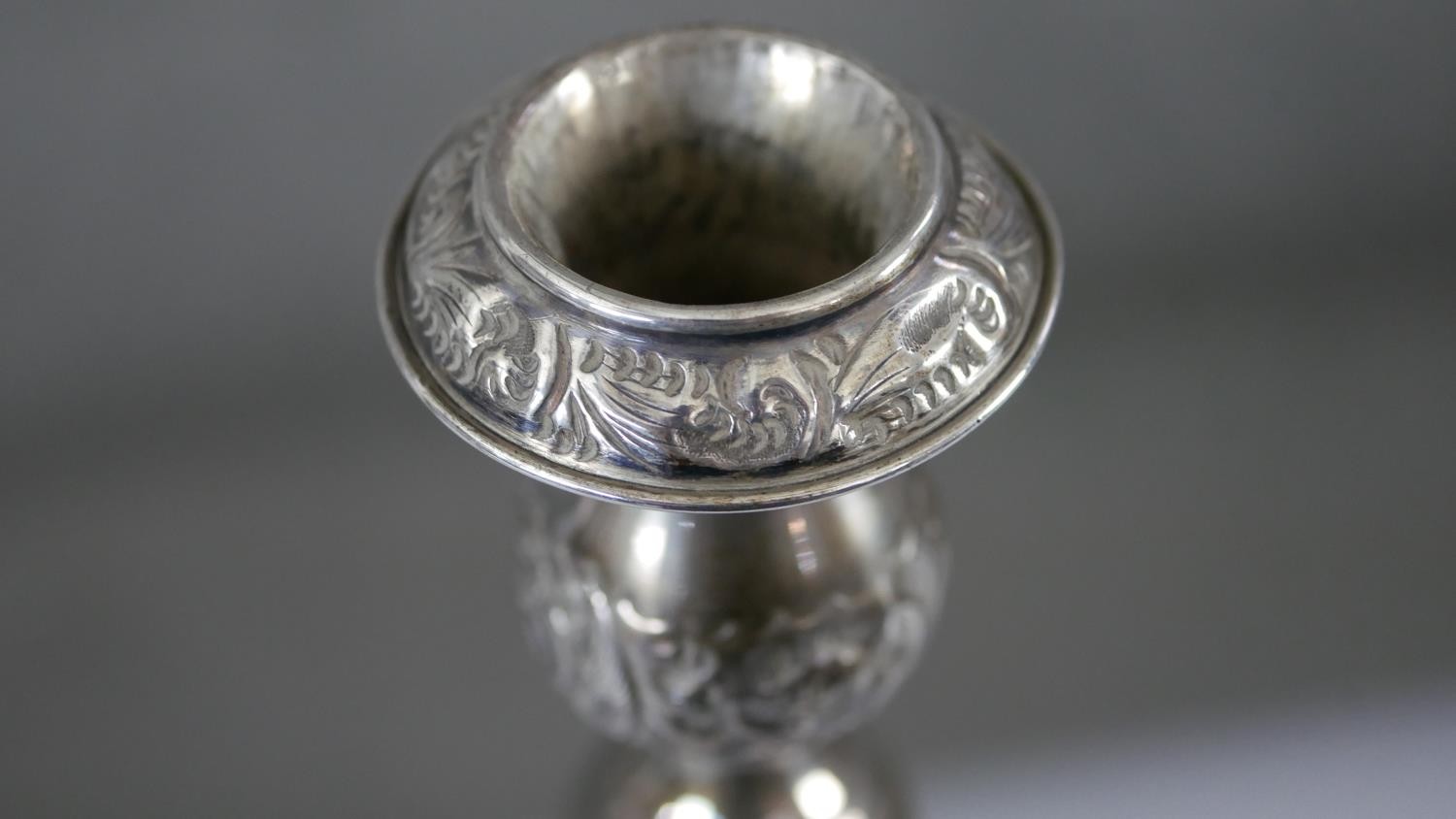 A pair of 1920'a repousse silver candlesticks with scrolling foliate design on scalloped bases. - Image 6 of 8