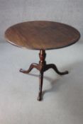 A Georgian mahogany tilt top table on baluster turned column and tripod cabriole supports. H.71