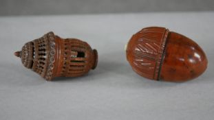 Two 19th century carved coquilla nut sewing cases, one in the form of an acorn with foliate design