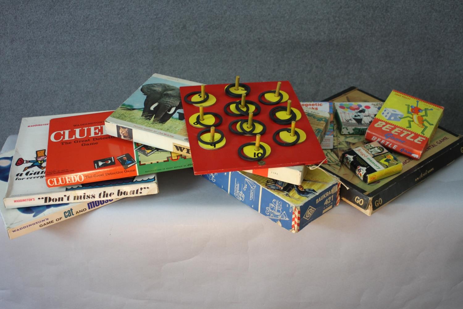 A collection of vintage toys and games. Including Cluedo, Beetle, Dont Miss the Boat, Go and a