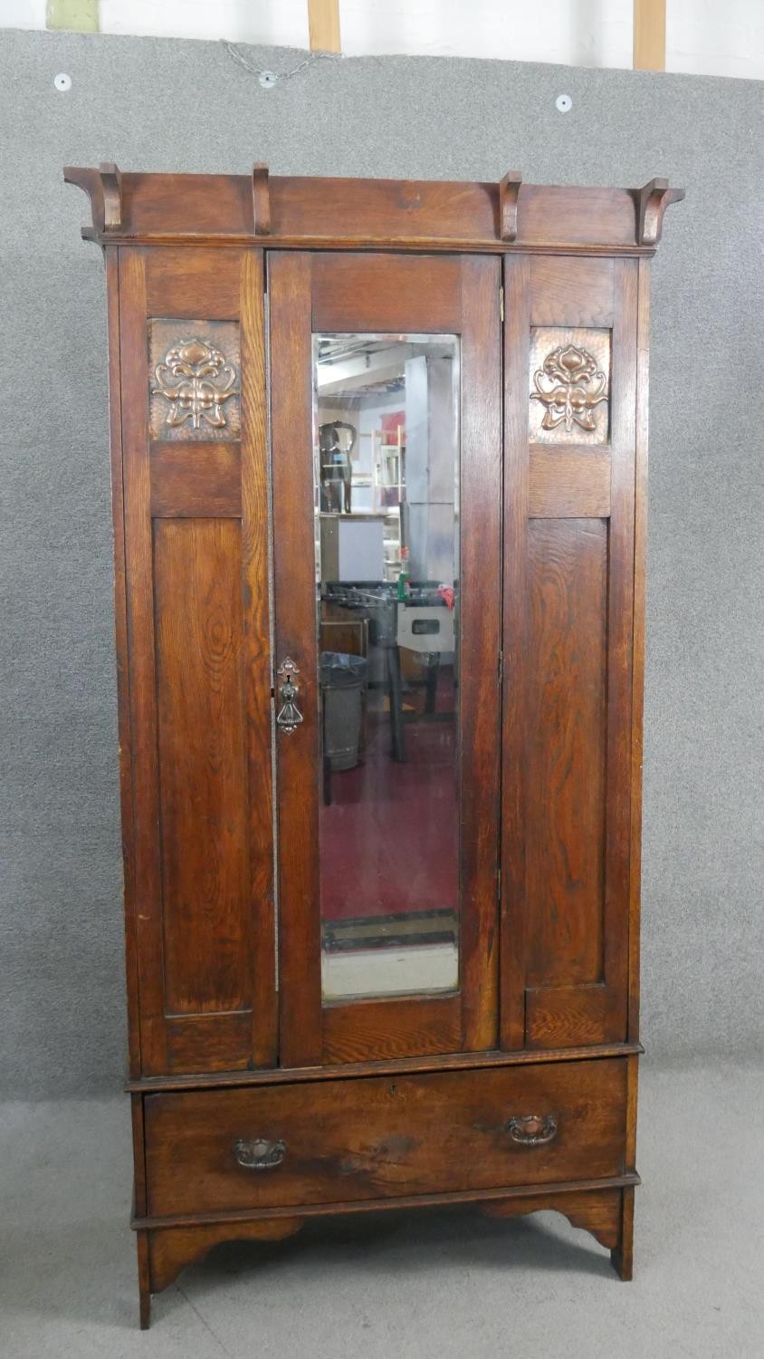 A late 19th century oak Arts and Crafts wardrobe with inset embossed copper panels. H.190 W.89 D.