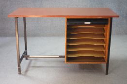 A mid century vintage teak desk on a metal frame with integral tambour fronted filing pedestal. H.74