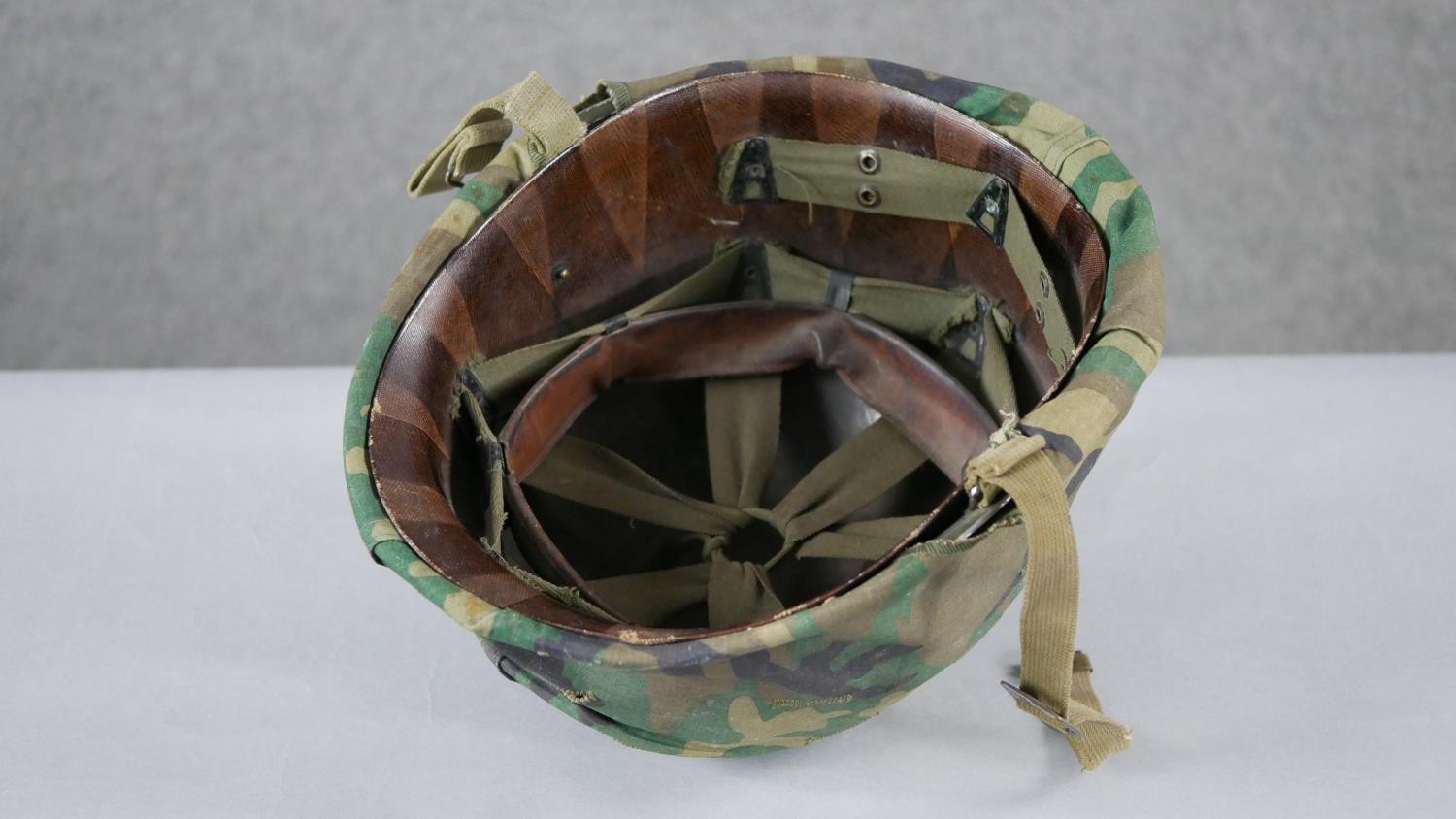 A WW2 US Schlueter helmet with camouflage canvas hood liner. H15 W.24 D.28cm - Image 2 of 5