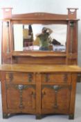 A Wolfe and Hollander Arts and Crafts period oak sideboard with all over applied hammered copper