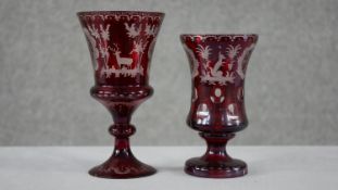 Two early 20th century Bohemian ruby cut to clear glass engraved goblets. One decorated with