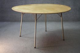 A mid century vintage Heal's dining table on metal supports with maker's label to the underside. H.