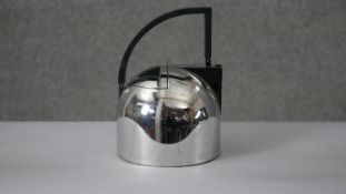 An Oliver Hemming stainless steel tea pot with abstract design. H.20 Diam.15cm