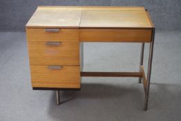 A 1960's vintage teak Stag Fineline metal framed dressing table with lift up vanity mirror by John