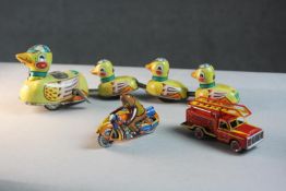 A collection of three vintage tin plate toys. Including a Blic duck family wind up toy with key