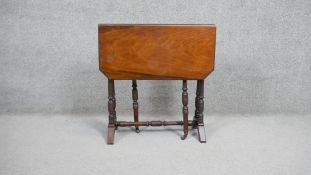 A 19th century mahogany drop flap Sutherland table on ring turned tapering supports. H64 W69 D60