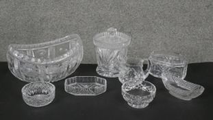 A collection of eight cut crystal pieces. Including a boat shaped crystal bowl, a lidded cut crystal
