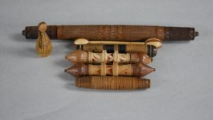 A collection of treen items. Including needle cases, peg doll and a sewing instrument. L.23cm (