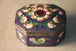 A Mogul style octagonal Indian silver and enamel snuff box, decorated with birds and lotus