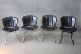 A set of four vintage Harry Bertoia model 420c dining chairs on metal wirework frames. Comes with