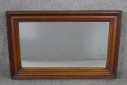 A C.1900 wall mirror in moulded and reeded mahogany frame. H.80 W.54cm