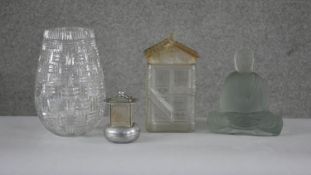 A collection of glassware. Including a cut crystal vase, a frosted glass cookie jar in the form of a